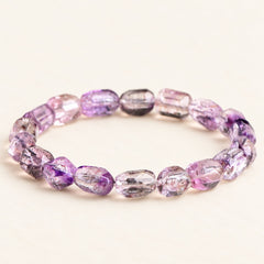 Plum Facets — Super Seven Quartz Barrel Bracelet, product detail on warm ivory