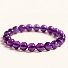 Violet Reserve — Amethyst Round Beads on a warm ivory background