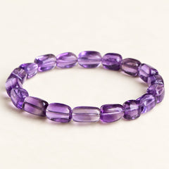 Violet Drift — Freeform Amethyst Bead Bracelet on a warm ivory studio background