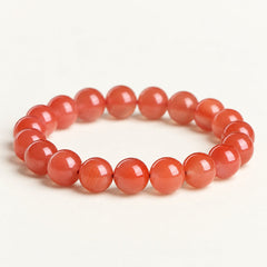 Cherry Ember — Red Agate Bead Bracelet on a warm ivory studio background