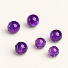 Velvet Violet — Amethyst Round Bead on a warm ivory studio background