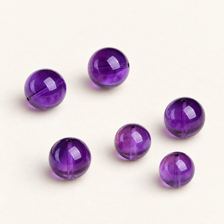 Velvet Violet — Amethyst Round Bead on a warm ivory studio background