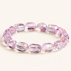 Plum Facets — Super Seven Quartz Barrel Bracelet, product detail on warm ivory