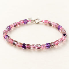 Aurora Drift — Freeform Super Seven Quartz Bracelet on a warm ivory studio background