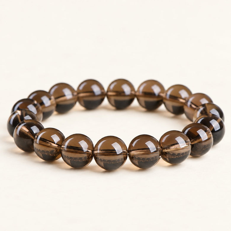 Smoky Stillness — Smoky Quartz Bead Bracelet on a warm ivory background