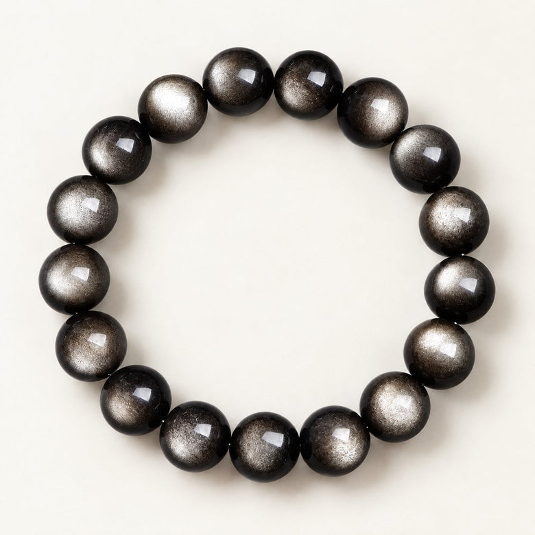 Silver Gaze — Silver Sheen Obsidian Bead Bracelet on a warm ivory studio background