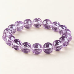 Violet Prism — Faceted Amethyst Bead Bracelet on a warm ivory background