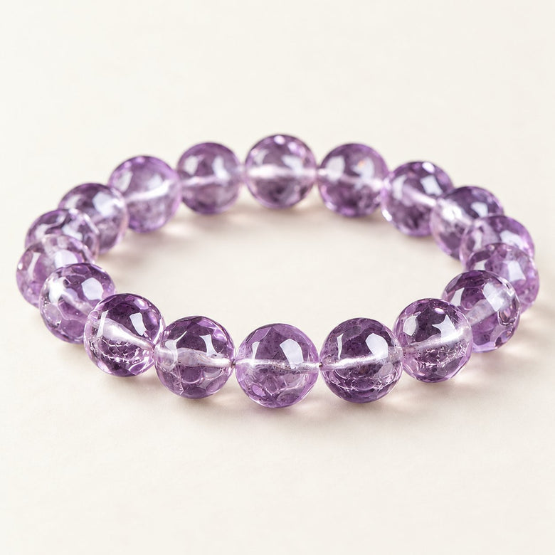 Violet Prism — Faceted Amethyst Bead Bracelet on a warm ivory background