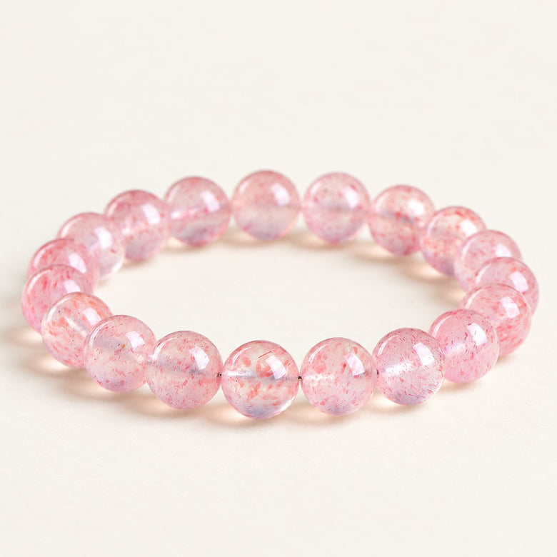 Petal Light — Strawberry Quartz Bead Bracelet on a warm ivory studio background