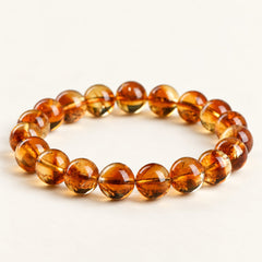 Golden Layers — Citrine Bead Bracelet on a warm ivory background