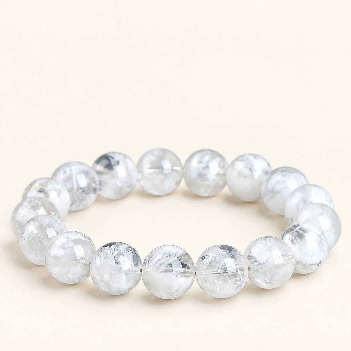 Snowfall — White Phantom Quartz Bead Bracelet on a warm ivory background