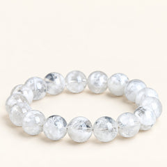 Snowfall — White Phantom Quartz Bead Bracelet on a warm ivory background