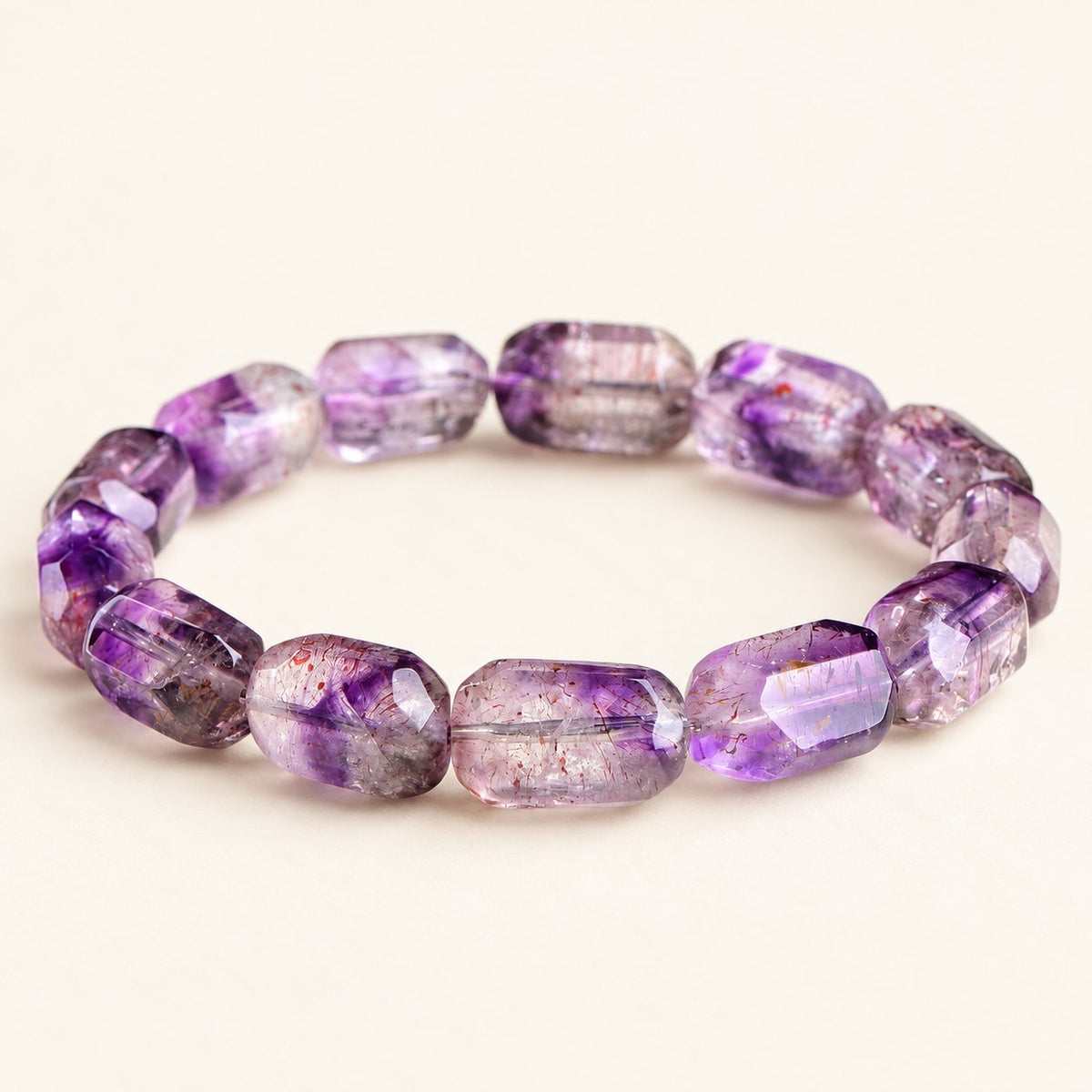 Plum Facets — Super Seven Quartz Barrel Bracelet, product detail on warm ivory