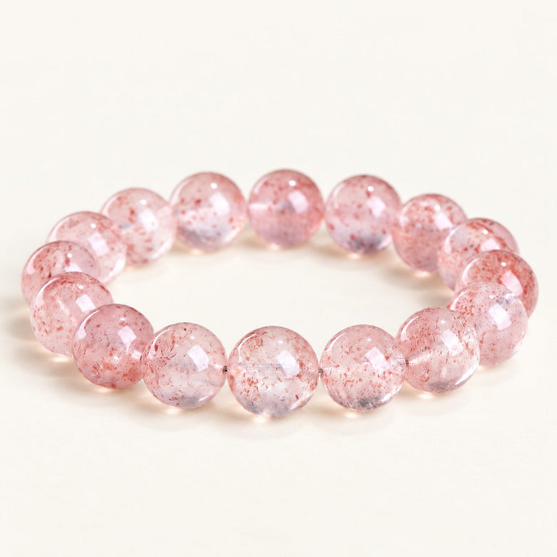 Scarlet Bloom — Strawberry Quartz Bead Bracelet on a warm ivory studio background