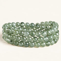Forest Veil — Green Included Quartz Bead Bracelet on a warm ivory background
